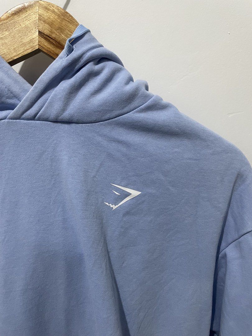 Gymshark Light Blue Hoodie Size S (Category: Coats, Jackets and Outerwear) located in Roxas City. Submitted by thrift_by_tons (Listing ID 1467088922, Image 2). Description: - Brand: Gymshark - Color: Light Blue - Size: Small (S) - Material: 70% Cotton, 30% Polyester - Features: Front kangaroo pocket, adjustable drawstring hood, white logo on left chest - Condition: Great for workouts or casual streetwear - Care: Wash inside out with similar color