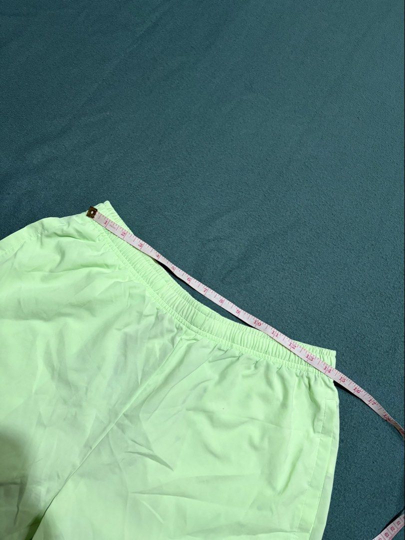 Gymshark Light Green Athletic Shorts Size L (Category: Shorts) located in Guihulngan. Submitted by fbthriftgoodsniace (Listing ID 1467094478, Image 3). Description: - Brand: Gymshark - Color: Light green - Size: L (tag inside waistband) - Features: Side pockets, black adjustable drawstring with Gymshark branding, white logo near hem - Material: Lightweight, ideal for workouts or running - Measurements: ~18" across the waist, ~18" total length -Ne