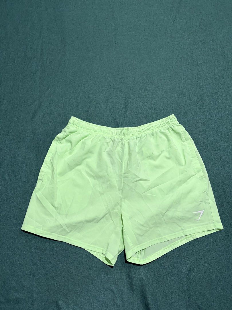 Gymshark Light Green Athletic Shorts Size L (Category: Shorts) located in Guihulngan. Submitted by fbthriftgoodsniace (Listing ID 1467094478, Image 1). Description: - Brand: Gymshark - Color: Light green - Size: L (tag inside waistband) - Features: Side pockets, black adjustable drawstring with Gymshark branding, white logo near hem - Material: Lightweight, ideal for workouts or running - Measurements: ~18" across the waist, ~18" total length -Ne