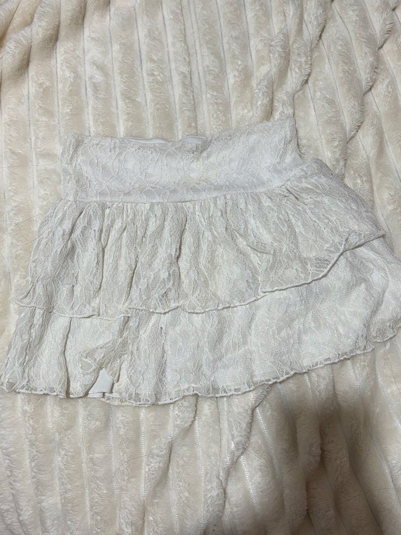 H& M White Lace Layered Ruffle Skirt (Category: Skirts) located in Quezon City. Submitted by hadescloset (Listing ID 1467057701, Image 1). Description: - Kids size but can fit XS adult - Color: White - Style: Lace mini skirt with all-over layered ruffles - Waistband: Elastic for an easy and comfortable fit - Material: Soft, textured fabric with a delicate pattern - Condition: Excellent, no flaws noticed - Perfect for: Summer outfits and casual la