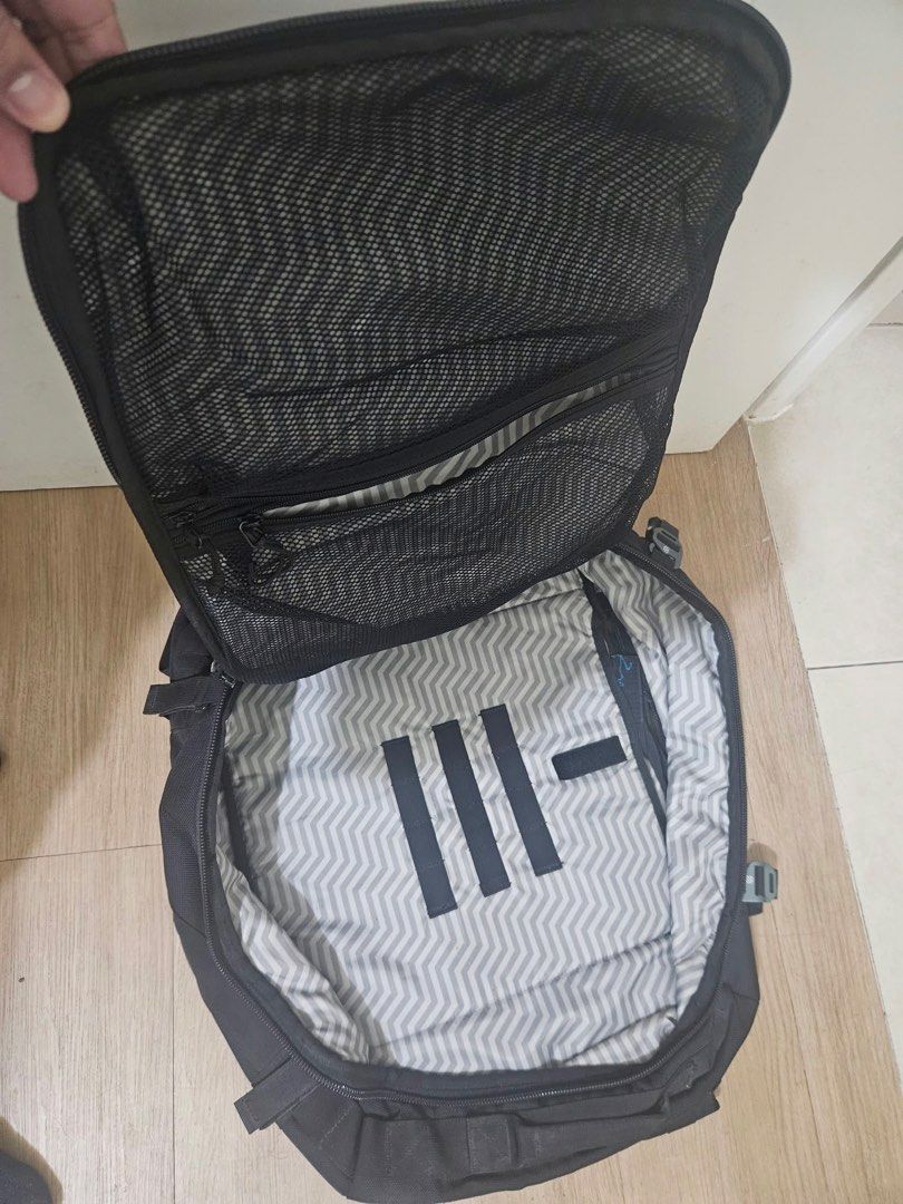 Haimplanet monolith 40L Black travel backpack with chevron interior lining and multiple compartments (Category: Backpacks) located in Taguig. Submitted by joyvillanueva (Listing ID 1466971996, Image 2). Description: - Color: Sleek black with a grey chevron pattern inside - Storage: Wide-opening main compartment with dual mesh zip pockets and a front top pocket - Exterior: Features modular webbing strips and a safety reflective stripe - Comfort: P