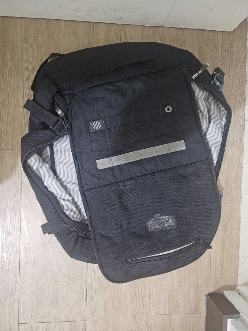 Haimplanet monolith 40L Black travel backpack with chevron interior lining and multiple compartments (Category: Backpacks) located in Taguig. Submitted by joyvillanueva (Listing ID 1466971996, Image 1). Description: - Color: Sleek black with a grey chevron pattern inside - Storage: Wide-opening main compartment with dual mesh zip pockets and a front top pocket - Exterior: Features modular webbing strips and a safety reflective stripe - Comfort: P