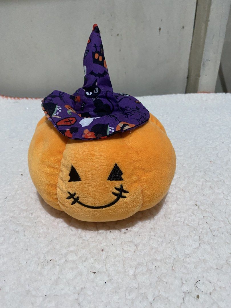Halloween Pumpkin Plush with Witch Hat (Category: Plushies & Soft Toys) located in Manila. Submitted by resi.diaz (Listing ID 1467144142, Image 1). Description: - 6” Diameter - Adorable orange pumpkin plush toy with a festive purple witch hat - Features a spooky-cute pattern of black cats, bats, houses, and ghosts on the hat - Detailed with charming embroidered eyes, nose, and a stitched mouth - Made from super soft fabric and designed to be ligh