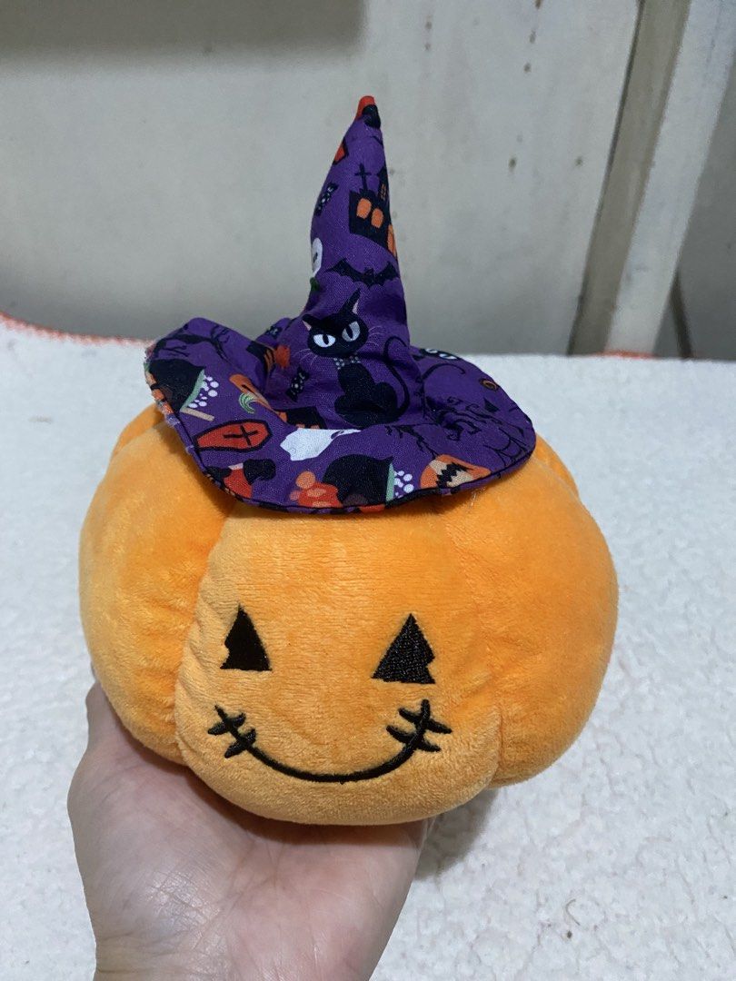 Halloween Pumpkin Plush with Witch Hat (Category: Plushies & Soft Toys) located in Manila. Submitted by resi.diaz (Listing ID 1467144142, Image 2). Description: - 6” Diameter - Adorable orange pumpkin plush toy with a festive purple witch hat - Features a spooky-cute pattern of black cats, bats, houses, and ghosts on the hat - Detailed with charming embroidered eyes, nose, and a stitched mouth - Made from super soft fabric and designed to be ligh