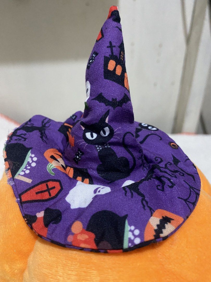 Halloween Pumpkin Plush with Witch Hat (Category: Plushies & Soft Toys) located in Manila. Submitted by resi.diaz (Listing ID 1467144142, Image 3). Description: - 6” Diameter - Adorable orange pumpkin plush toy with a festive purple witch hat - Features a spooky-cute pattern of black cats, bats, houses, and ghosts on the hat - Detailed with charming embroidered eyes, nose, and a stitched mouth - Made from super soft fabric and designed to be ligh