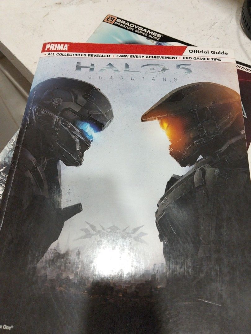 Halo 5 Guardians Prima Official Game Guide (Category: PlayStation) located in Cagayan de Oro. Submitted by Jboybibs10 (Listing ID 1467134212, Image 1). Description: - Official Halo 5 Guardians strategy guide by Prima Games - Features Master Chief and Spartan Locke cover design - Clean interior pages with minor edge wear on the spine - Includes complete collectible guides and achievement walkthroughs - Packed with pro gamer tips to help you finish