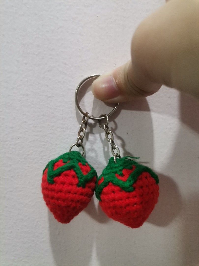 Handmade crochet strawberry keychain charm set (Category: Handmade Craft) located in Makati City. Submitted by kookybearsstuff (Listing ID 1467090785, Image 1). Description: - Handmade crochet strawberry charm keychain - Features two cute red strawberries with green stitched tops - Attached to a sturdy metal keychain ring with linked chains - Perfect aesthetic accessory for keys, bags, and backpacks - Coming from a clean, smoke-free home.