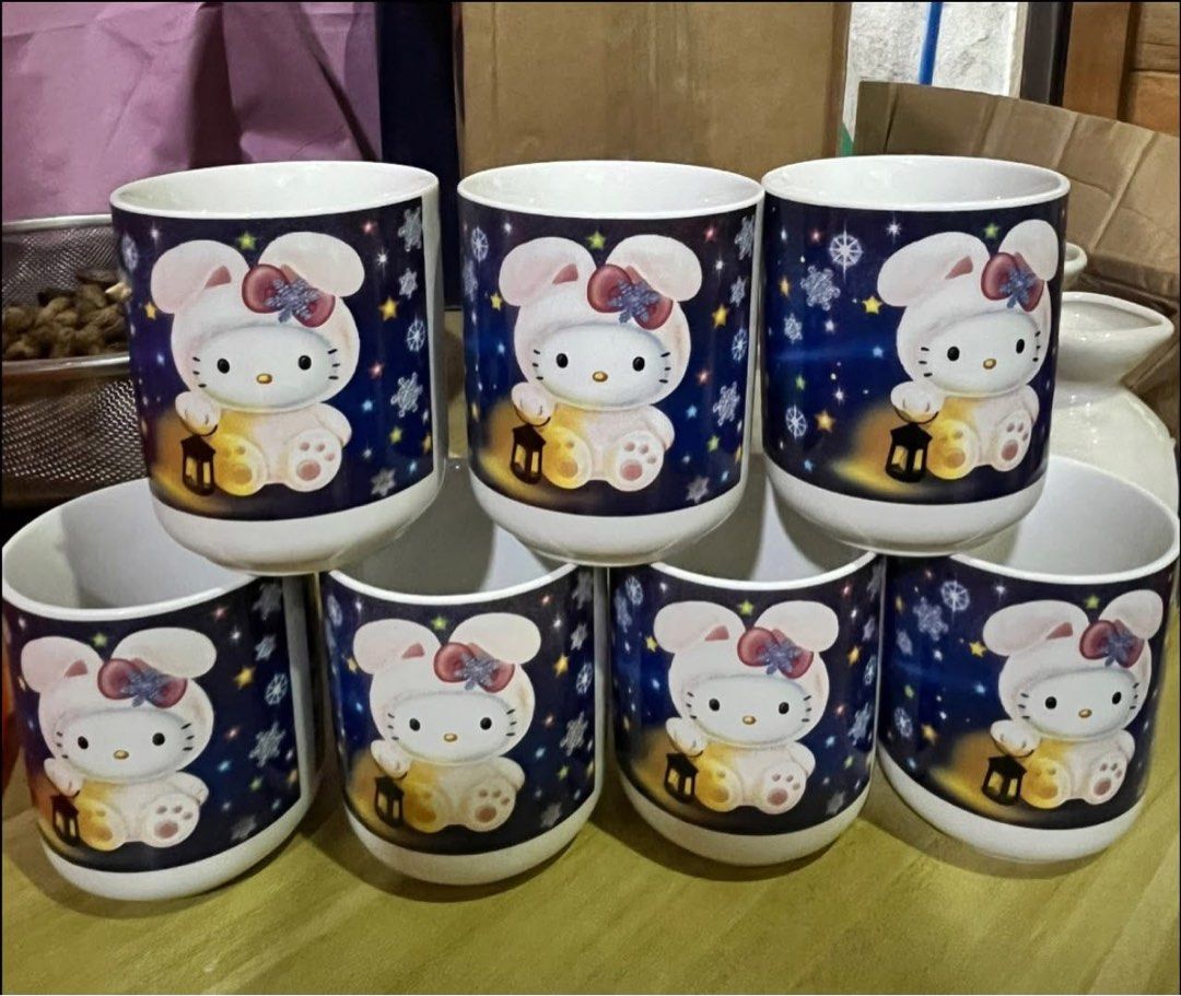 Hello Kitty ceramic mugs set of 7 (Category: Coffee & Tea Tableware) located in Manila. Submitted by janetecson05 (Listing ID 1467006870, Image 1). Description: - Set of 7 matching Kitty ceramic mugs - Charming dark blue starry night design with snowflakes and lanterns - Clean white interior with a comfortable handleless tea bowl shape - Sold as a complete bundle - Perfect for collecting, gifting, or cozy tea times.