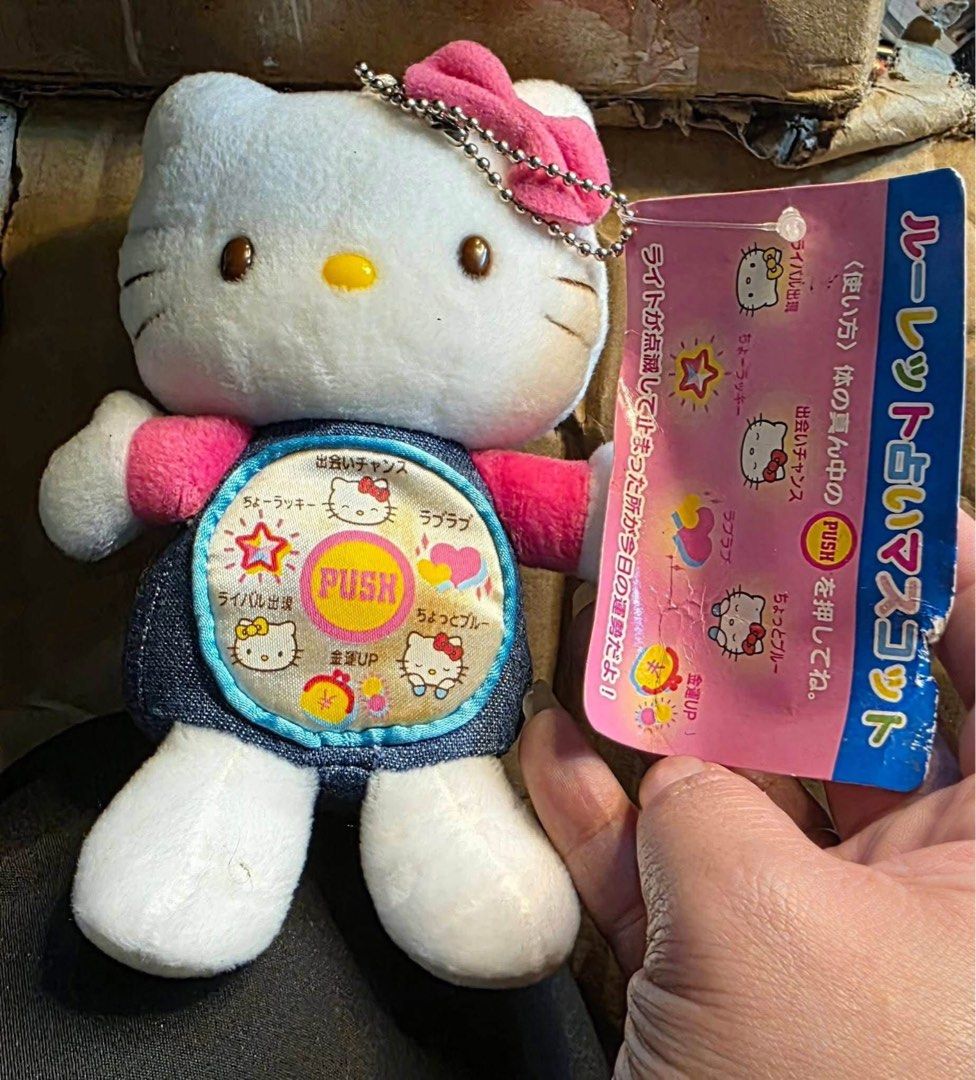 Hello Kitty Roulette Fortune Mascot Plush Keychain (Category: Plushies & Soft Toys) located in Manila. Submitted by janetecson05 (Listing ID 1467005925, Image 1). Description: - Authentic Sanrio Kitty plush mascot with a convenient ball chain keychain - Adorable outfit featuring denim overalls and a pink shirt with a matching pink ribbon bow - Interactive front roulette wheel design with Japanese text and a yellow 'PUSH' center button - Comes com