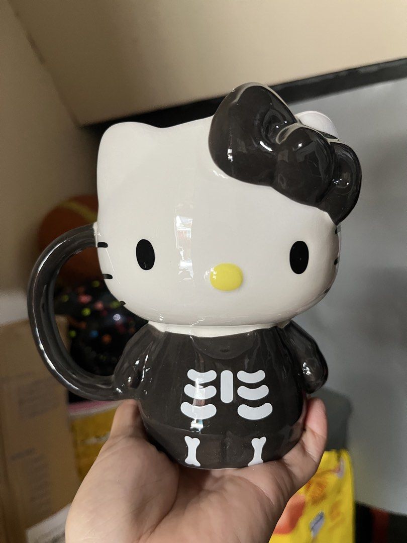 Hello Kitty Skeleton Costume Ceramic Mug 20 oz Silver Buffalo (Category: Coffee & Tea Tableware) located in Manila. Submitted by janetecson05 (Listing ID 1467060894, Image 1). Description: - Official Sanrio merchandise by Silver Buffalo - Design: Kitty in a black skeleton costume with a matching black bow - Capacity: Large 20-ounce sculpted novelty mug - Perfect for hot drinks, collection, or display - Care instructions: Hand wash only (Not micro