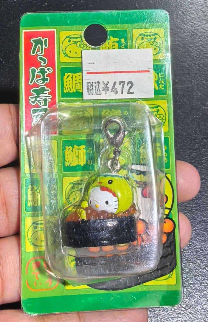 Hello Kitty Sushi Kappa Zushi Charm Keychain (Category: Character Goods) located in Manila. Submitted by janetecson05 (Listing ID 1467058876, Image 1). Description: - Rare Sanrio collectible imported from Japan - Features Kitty dressed as a Kappa Zushi sushi mascot - Brand new and sealed in original green packaging - Original Japanese text and price tag still attached - Equipped with a metal lobster clasp clip for easy attachment - Perfect for Ki
