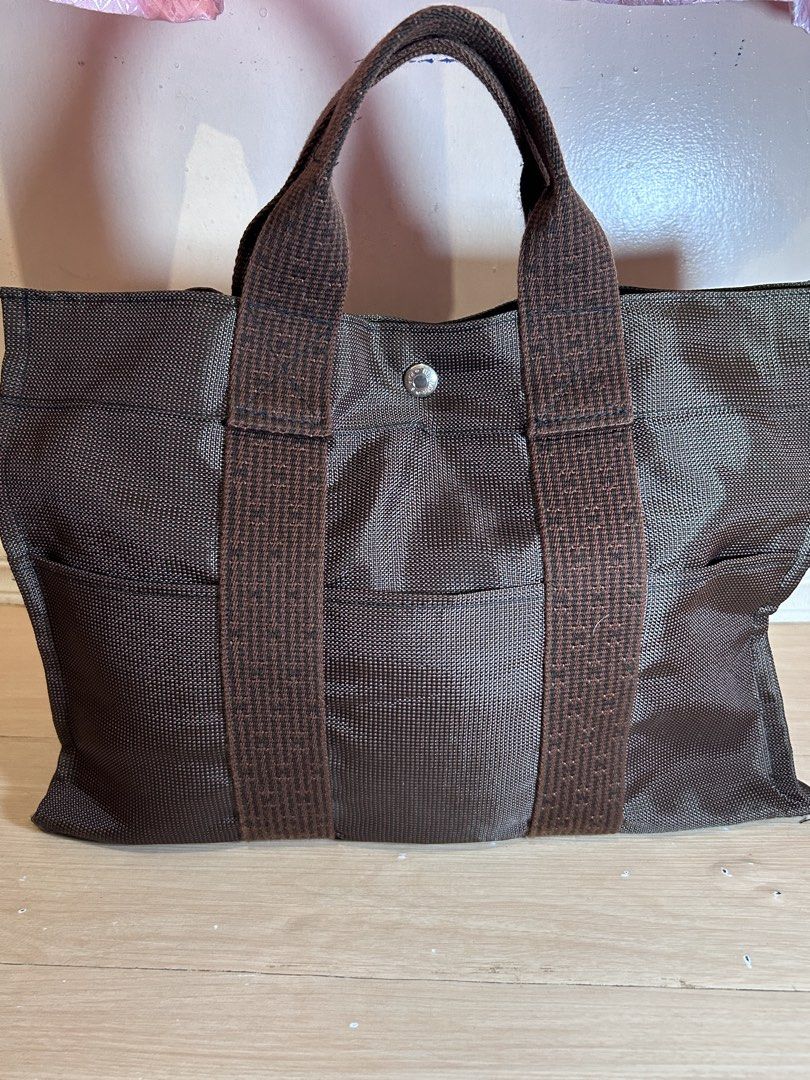 Hermes Herline MM handbag Bag Brown (Category: Luxury Bags & Wallets) located in Dipolog. Submitted by adrian281994 (Listing ID 1467077590, Image 2). Description: - Authentic Hermes herline MM brown tote bag - rich chocolate brown shade - Dual sturdy top handles with contrasting woven texture - Convenient open front pocket structure - Secure central snap button closure with branding stamp - Spacious interior ideal for daily essentials, commutes, 