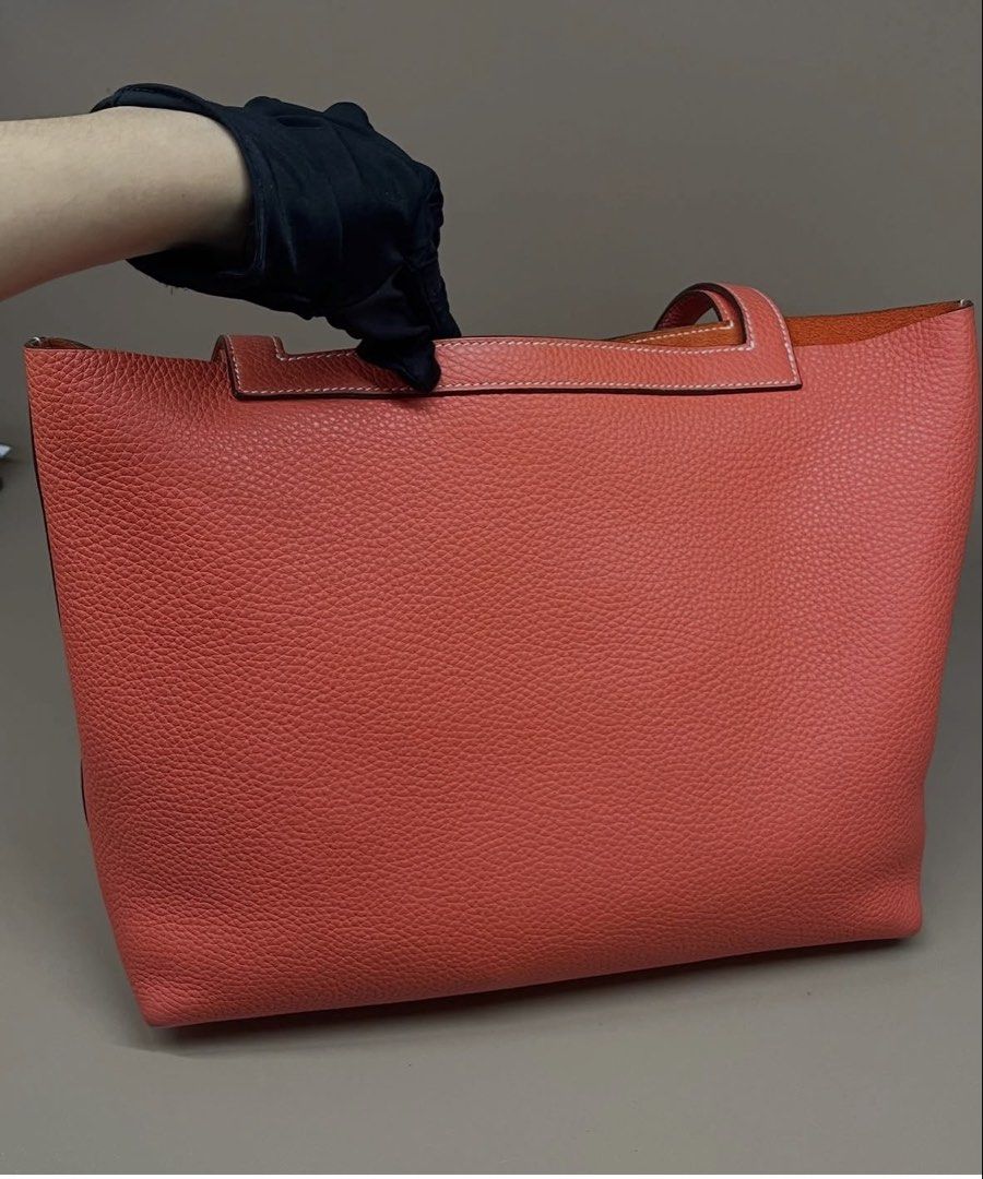Hermès Cabasellier 31 (Category: Tote Bags) located in Makati City. Submitted by dgcurated09 (Listing ID 1467147443, Image 2). Description: - Authentic Hermès tote bag in vibrant orange pebbled leather - Open top design with comfortable dual shoulder straps - Luxurious unlined suede interior in a matching orange tone - Structured base with reinforced stitched corners for durability - Impeccable condition with zero scuffs or scratches - Sleek hard