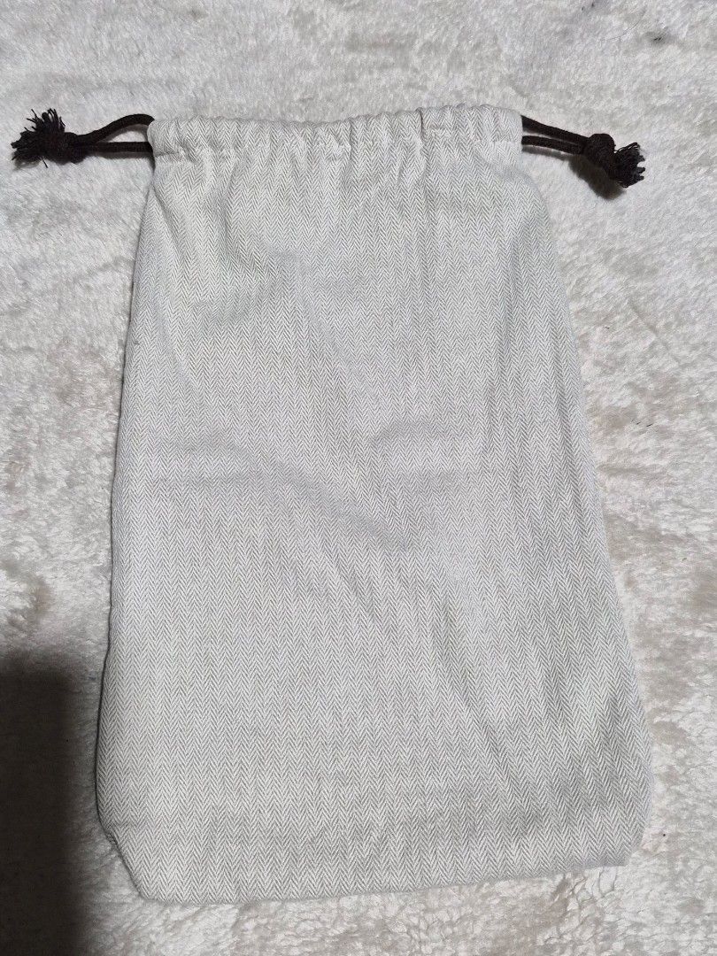 Hermès herringbone dust bag with drawstring closure 12 x 7 inches (Category: Baby Monitors) located in Mandaue City. Submitted by chuchi152615 (Listing ID 1466972985, Image 3). Description: - Hermès dust bag - Made from premium beige herringbone fabric - Features dark brown drawstrings on both sides with knotted ends - Clear central circular logo with the classic horse-drawn carriage and 'H' - Clean fabric and pristine print - Ideal for storing l