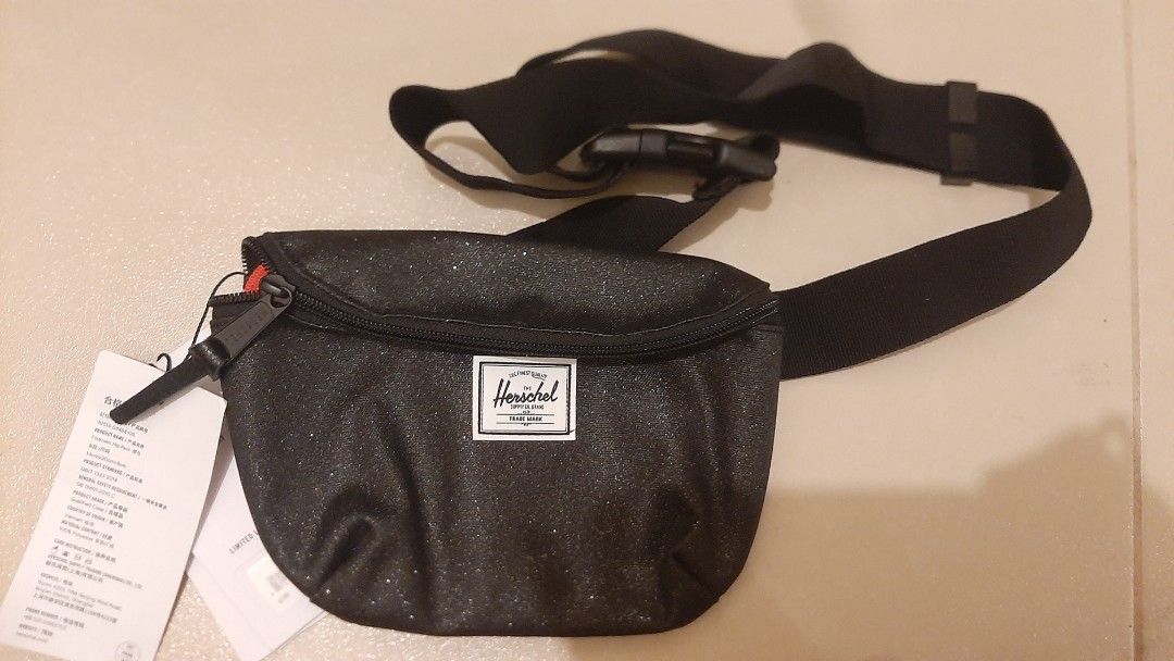 Herschel Supply Co. Black Glitter Hip Pack (Category: Cross-body Bags) located in Quezon City. Submitted by macieee39997 (Listing ID 1466976783, Image 2). Description: - Brand: Herschel (hip pack model) - Color/Finish: All-over black sparkle glitter - Condition: Brand new with original tags attached - Features: Adjustable black waist strap with secure plastic buckle and zippered main compartment - Interior: Clean fabric lining.