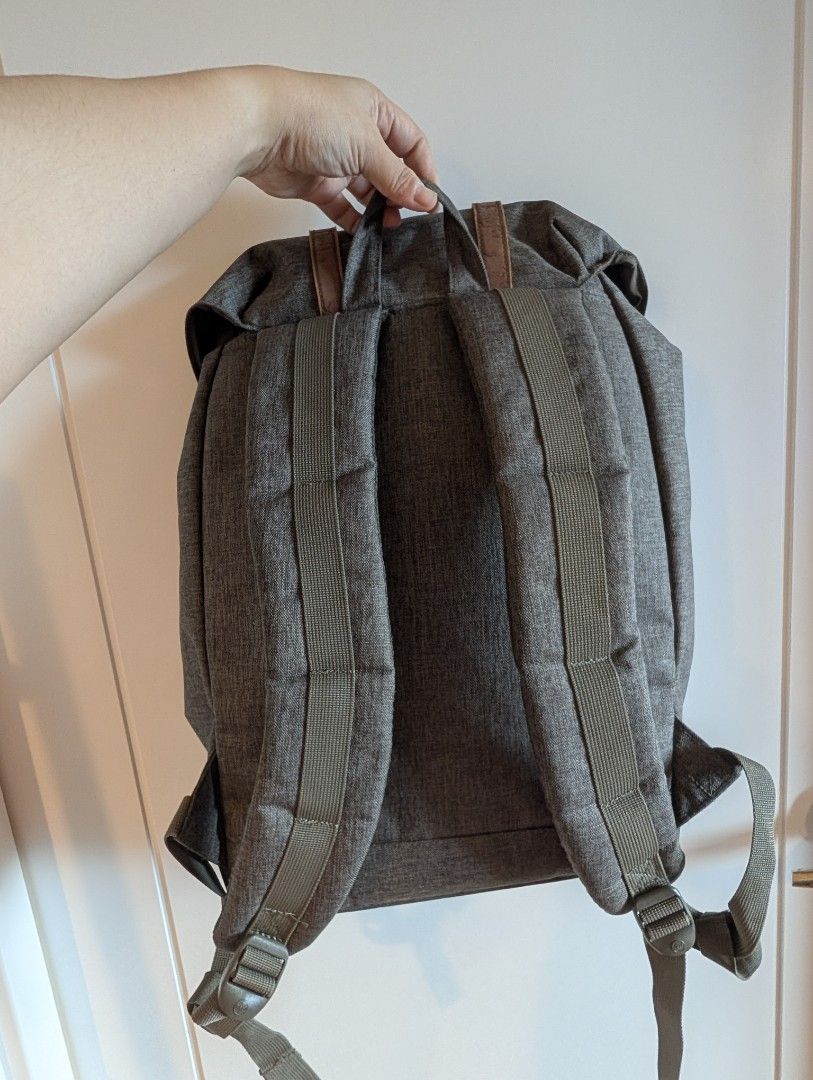 Herschel Supply Co. Grey Backpack (Category: Backpacks) located in Quezon City. Submitted by wilddolphin.bd524c (Listing ID 1467015733, Image 3). Description: - Brand: Herschel Supply Co. - Color: Grey heather with brown faux leather accents - Closure: Magnetic buckle and drawstring under main flap - Interior: Signature red and white striped lining with dedicated laptop sleeve - Comfort: Adjustable padded shoulder straps - Storage: Front pocket w