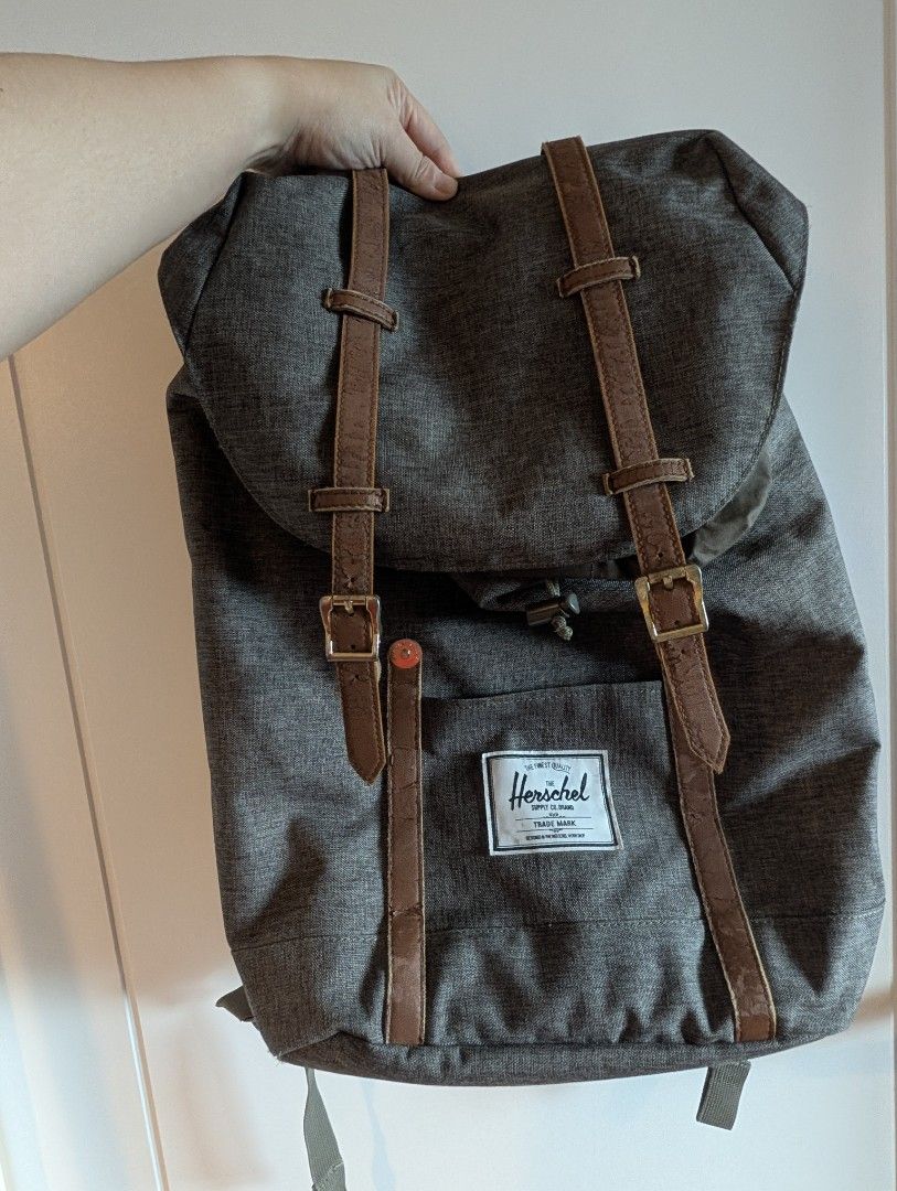 Herschel Supply Co. Grey Backpack (Category: Backpacks) located in Quezon City. Submitted by wilddolphin.bd524c (Listing ID 1467015733, Image 2). Description: - Brand: Herschel Supply Co. - Color: Grey heather with brown faux leather accents - Closure: Magnetic buckle and drawstring under main flap - Interior: Signature red and white striped lining with dedicated laptop sleeve - Comfort: Adjustable padded shoulder straps - Storage: Front pocket w