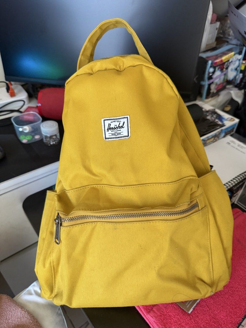 Herschel Yellow Backpack (Category: Backpacks) located in Makati City. Submitted by miguelcm (Listing ID 1466994091, Image 1). Description: - Authentic Herschel backpack in a vibrant bright yellow canvas - Iconic white woven logo patch on the front - Exterior features a front zippered pocket and two side slip pockets for water bottles - Comfortable top carry handle and adjustable shoulder straps - Signature red and white striped fabric lining wit