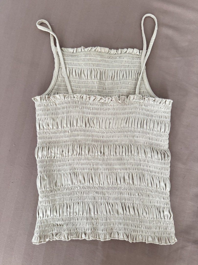 H&M beige smocked cami top size S (Category: Sleeveless) located in Manila. Submitted by maliwana.gan (Listing ID 1467029010, Image 2). Description: Fits XS to S Loc: Tomas Morato, QC Lalamove c/o buyer - Brand: H&M - Color: Beige - Size: EUR S / UK S / CN 165/88A - Design: Smocked cami with thin spaghetti straps and ruffled edges - Fit: Fully stretchy, super comfy all over.