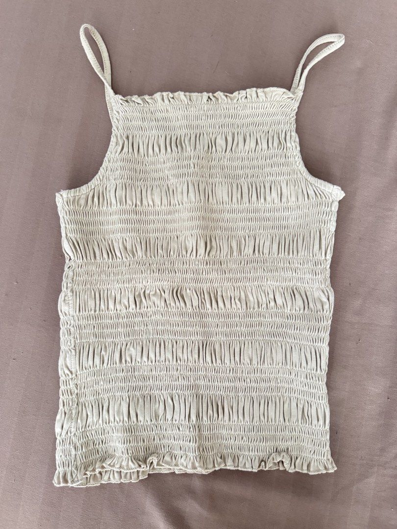 H&M beige smocked cami top size S (Category: Sleeveless) located in Manila. Submitted by maliwana.gan (Listing ID 1467029010, Image 1). Description: Fits XS to S Loc: Tomas Morato, QC Lalamove c/o buyer - Brand: H&M - Color: Beige - Size: EUR S / UK S / CN 165/88A - Design: Smocked cami with thin spaghetti straps and ruffled edges - Fit: Fully stretchy, super comfy all over.