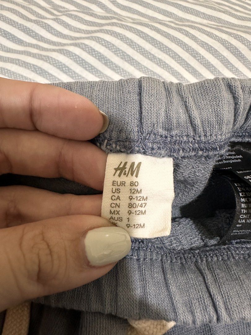 H&M Brown Overalls and Blue Joggers Bundle (Category: Babies & Kids Fashion) located in Taguig. Submitted by impulsivebuyer0225 (Listing ID 1467027587, Image 3). Description: - Brand: H&M - Quantity: Bundle of 2 pieces - Item 1: Dark brown baby overalls with tan front pockets (Size: EUR 74 / 9 months) - Item 2: Matching blue joggers with drawstring waist and elastic cuffs (Size: EUR 80 / 12 months) - Material: Soft cotton - Condition: Great for e