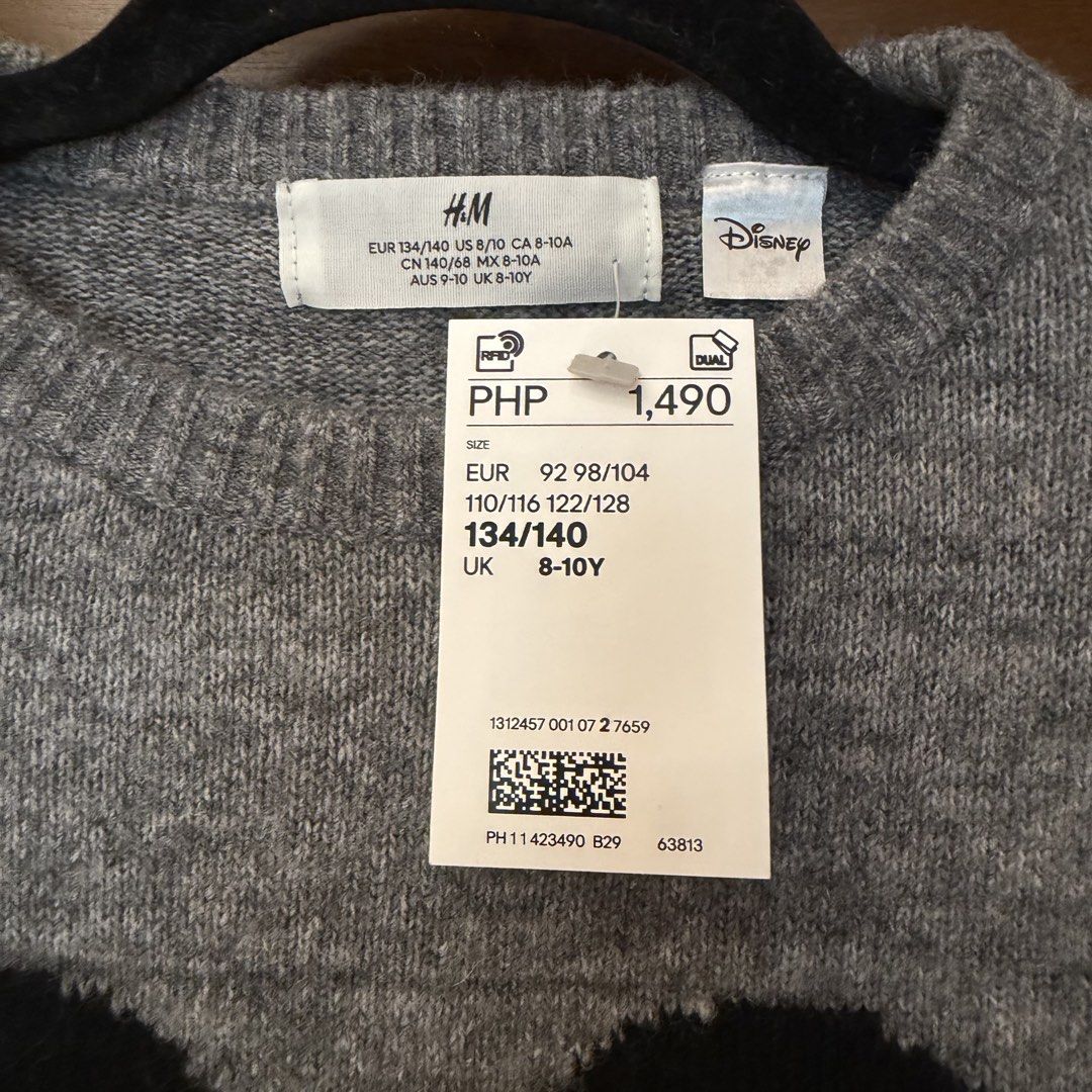 H&M Disney sweater (Category: Babies & Kids Fashion) located in Quezon City. Submitted by ksdong (Listing ID 1467009885, Image 3). Description: - Brand: H&M x Disney (Mickey Mouse collaboration) - Condition: Brand new with original retail tag (1,490 PHP) - Size: EUR 134/140, UK 8-10Y - Design: Large Mickey Mouse graphic in black, white, and red on grey knit - Details: Ribbed crew neck, cuffs, and hem - Material: Warm and cozy fabric, great for da