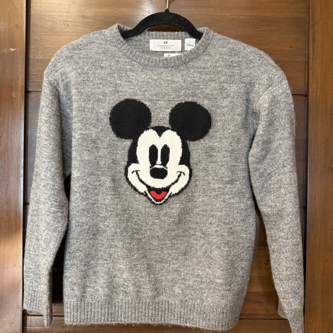 H&M Disney sweater (Category: Babies & Kids Fashion) located in Quezon City. Submitted by ksdong (Listing ID 1467009885, Image 1). Description: - Brand: H&M x Disney (Mickey Mouse collaboration) - Condition: Brand new with original retail tag (1,490 PHP) - Size: EUR 134/140, UK 8-10Y - Design: Large Mickey Mouse graphic in black, white, and red on grey knit - Details: Ribbed crew neck, cuffs, and hem - Material: Warm and cozy fabric, great for da