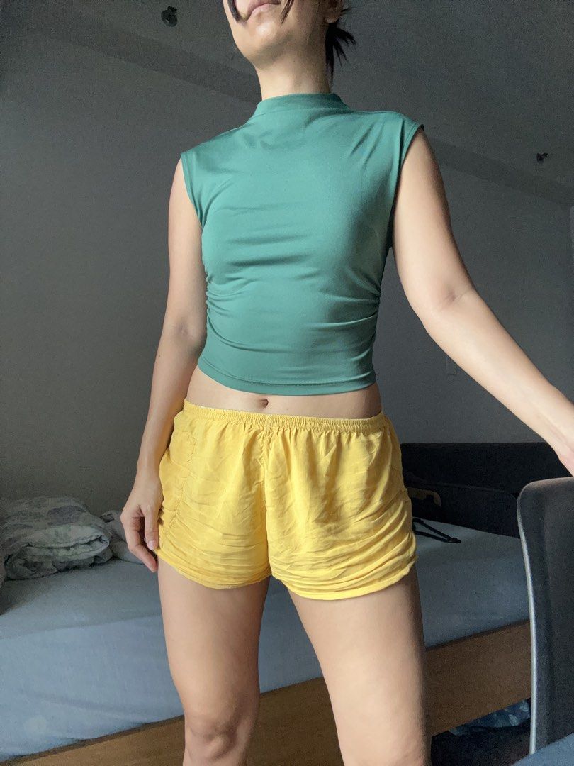 H&M Green Sleeveless Mock Neck Top (Category: Sleeveless) located in Makati City. Submitted by magwayr19 (Listing ID 1466982636, Image 3). Description: - Brand: H&M - Size: S (true to size) - Color: Green - Style: Sleeveless top with high mock neckline and gathered ruched sides.