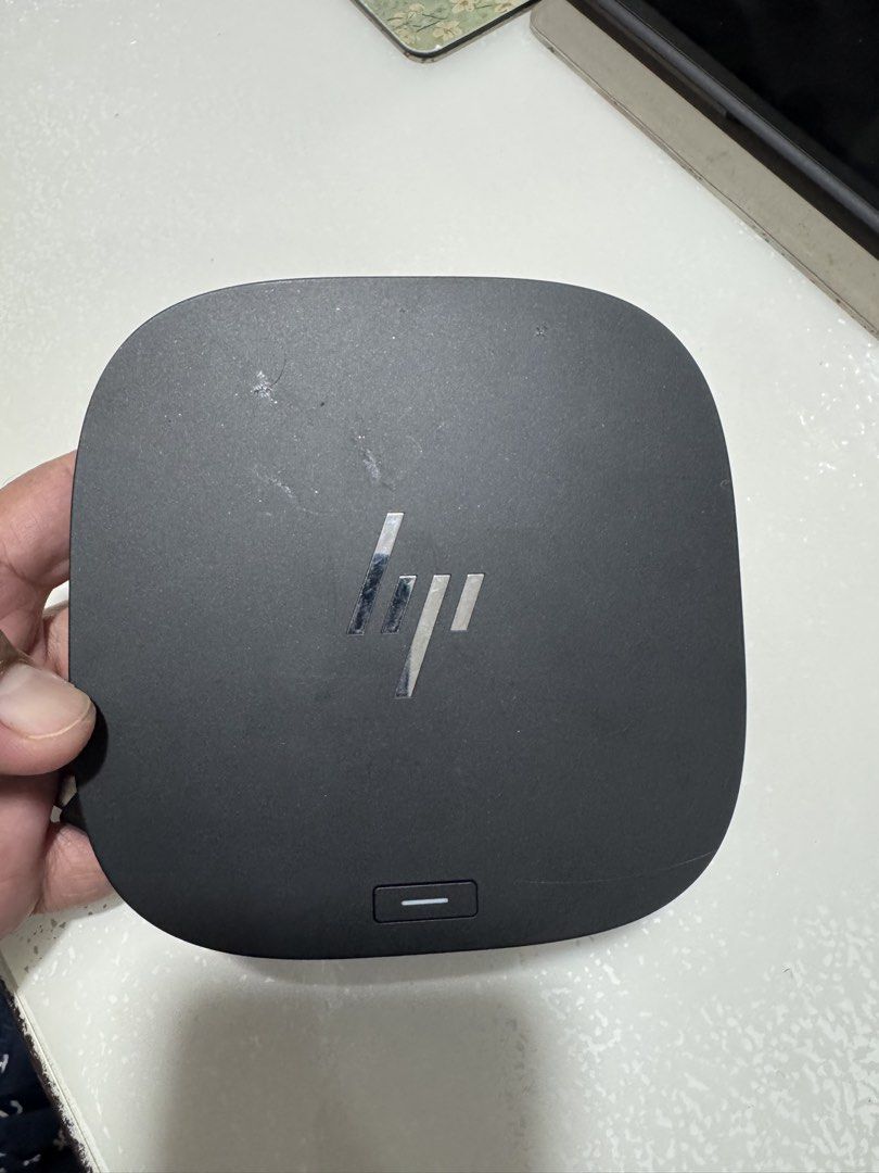 HP USB-C Dock G5 (Category: Cables & Adaptors) located in Cavite. Submitted by marcuz1316 (Listing ID 1467112259, Image 1). Description: - Genuine HP USB-C Dock G5 (Model: HSN-IX02) - Sleek black finish with silver HP logo - Multiple ports: HDMI, DisplayPort, Ethernet, and USB - Convenient integrated power button on top - Comes with attached cable for easy plug-and-play setup - Perfect for WFH setups or expanding laptop connectivity.