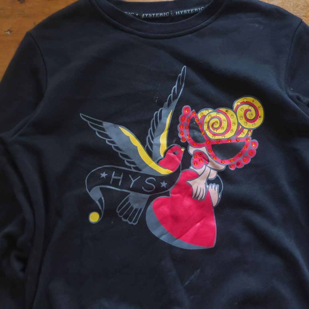 Hysteric Glamour sweater (Category: Coats, Jackets and Outerwear) located in Tayabas. Submitted by cat.b0i (Listing ID 1467093793, Image 3). Description: Size on tag: L Fitting: Men - L Women - L ‎Length: 23 ‎Width: 18 ‎Shoulder: 16 ‎Arm Space: 8 ‎Sleeve Length: 22 ‎ ‎Color: Dark blue with oatmeal grey accents Color Rate: 8.8 ‎Material: 95% cotton, 5% polyester properties: graphic is beaded ‎Issues: cut neck tag, minor (washable?) stains and mino