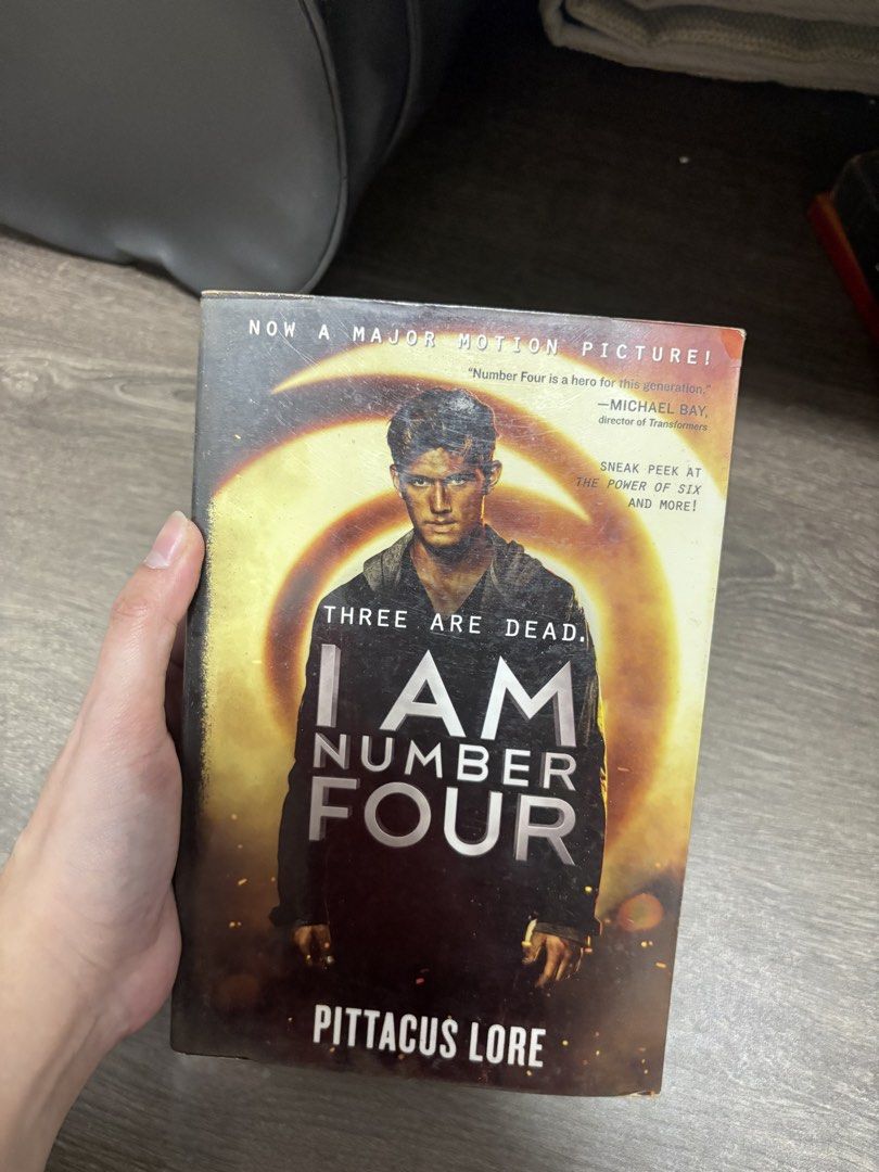 I Am Number Four by Pittacus Lore paperback (Category: Storybooks) located in Imus. Submitted by _monicakes (Listing ID 1467099415, Image 1). Description: - Title: I Am Number Four by Pittacus Lore - Edition: Movie tie-in with Alex Pettyfer poster cover - Publisher: Harper - Condition: Pages are yellowed from age, with cover edge wear and spine creasing - Genre: Young Adult / Sci-Fi.