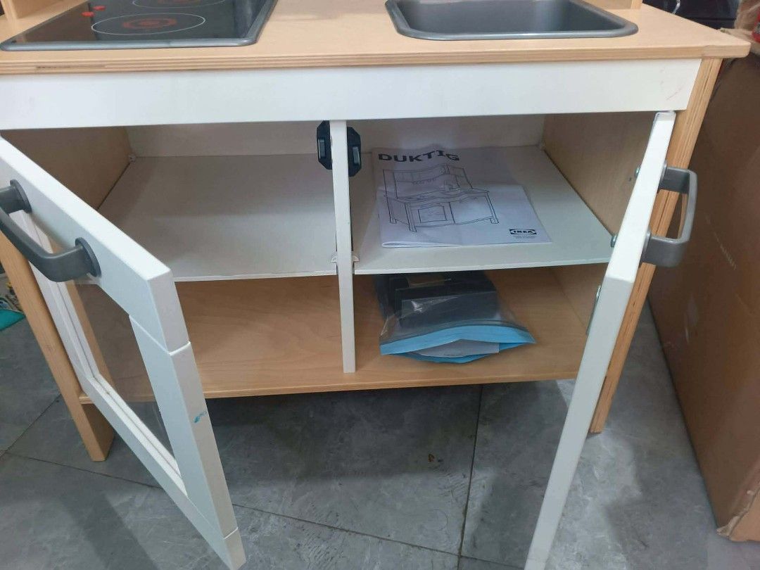 IKEA DUKTIG Play Kitchen Toy (Category: Kids Toys) located in Manila. Submitted by mateochest99469 (Listing ID 1467055893, Image 2). Description: - Item: IKEA DUKTIG Play Kitchen - Features: Wooden frame, stove top, sink, microwave, and lower cabinets - Inclusions: Original instruction manual and a bag of metal utensils - Condition: Clean, well-maintained, and great for imaginative play - Meet-up or delivery options available upon request.