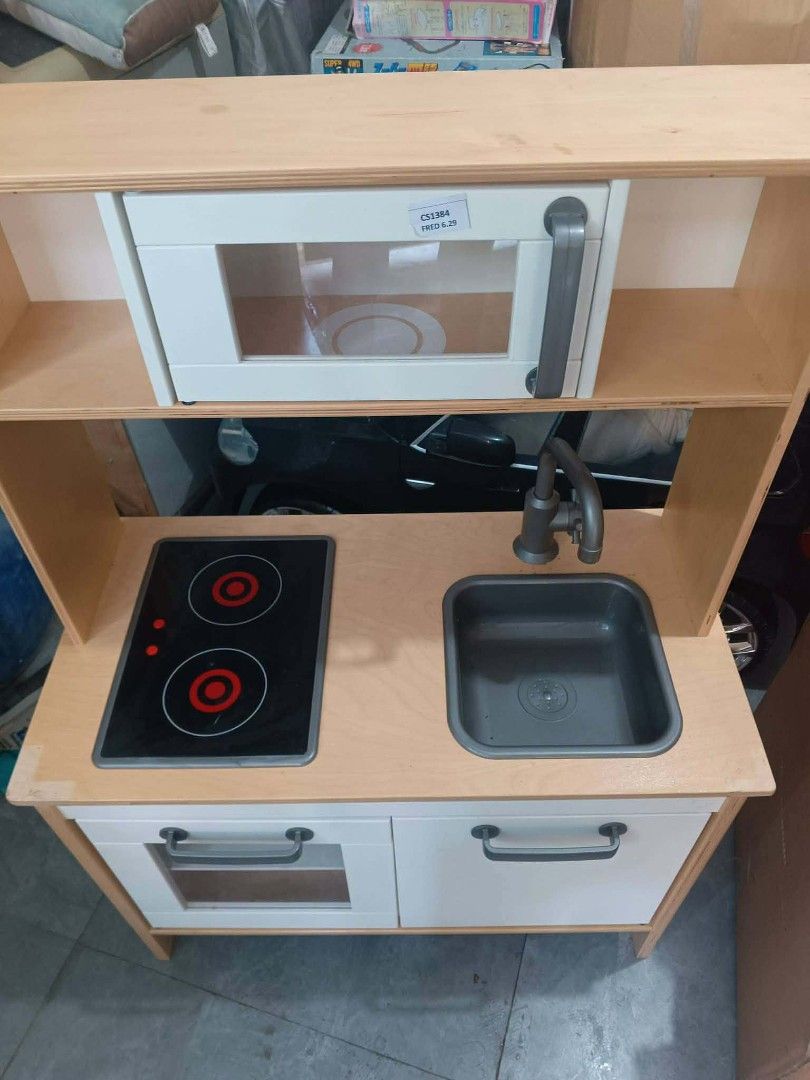 IKEA DUKTIG Play Kitchen Toy (Category: Kids Toys) located in Manila. Submitted by mateochest99469 (Listing ID 1467055893, Image 1). Description: - Item: IKEA DUKTIG Play Kitchen - Features: Wooden frame, stove top, sink, microwave, and lower cabinets - Inclusions: Original instruction manual and a bag of metal utensils - Condition: Clean, well-maintained, and great for imaginative play - Meet-up or delivery options available upon request.