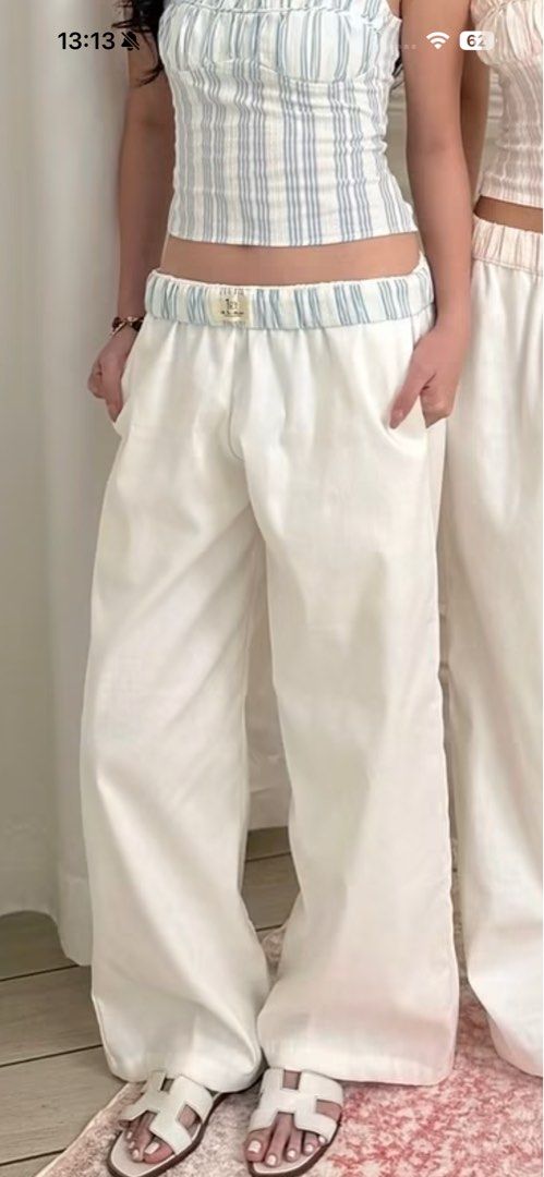 Isa The Label White Linen Pants (Blue) (Category: Jeans) located in Manila. Submitted by mixofsunshine_ (Listing ID 1467012364, Image 1). Description: - Brand: Isa The Label - Brand New - Size: Small - Color/Pattern: White with light blue vertical stripes - Fit: Relaxed wide-leg with elastic waistband - GCASH / MAYA - Lalamove / Grab.