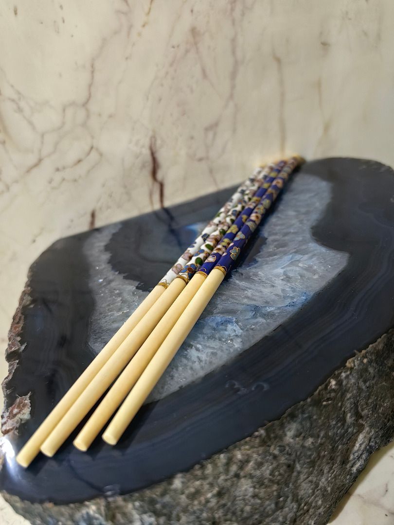 Ivory Chopstick - Set (2 Pairs) (Category: Dinnerware & Cutlery) located in Tarlac. Submitted by jeremiah.curator.2026 (Listing ID 1466917473, Image 1). Description: - Includes 2 pairs of decorative chopsticks - Features intricate floral designs (1 deep blue, 1 white) - Solid cream-colored lower halves with chic gold accent rings - Great for everyday dining or aesthetic kitchen display.