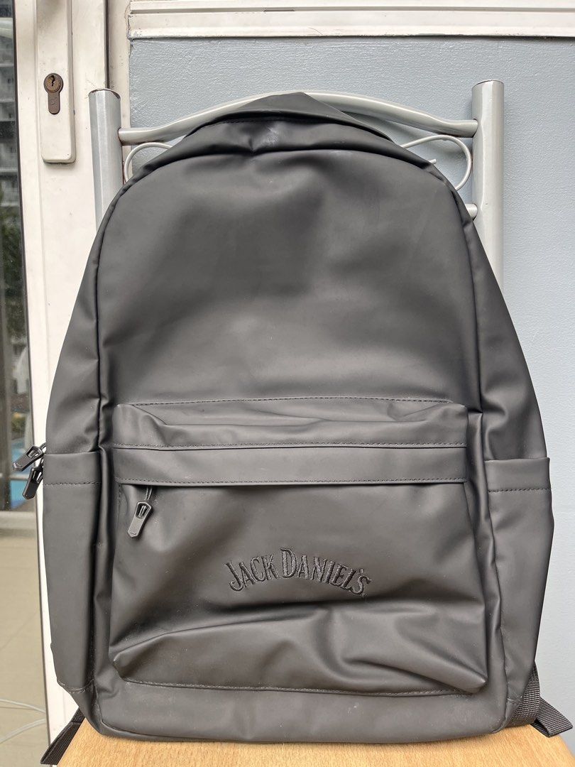 Jack Daniel's Black Waterproof Backpack (Category: Backpacks) located in Pasay City. Submitted by wear.id (Listing ID 1467155977, Image 1). Description: Jack Daniel's Backpack w/ luggage sleeve - color: solid black with smooth matte finish - stitched logo branding on the front pocket - double zipper main compartment and exterior front pouch with clean interior lining - adjustable shoulder straps - brand new / excellent quality.