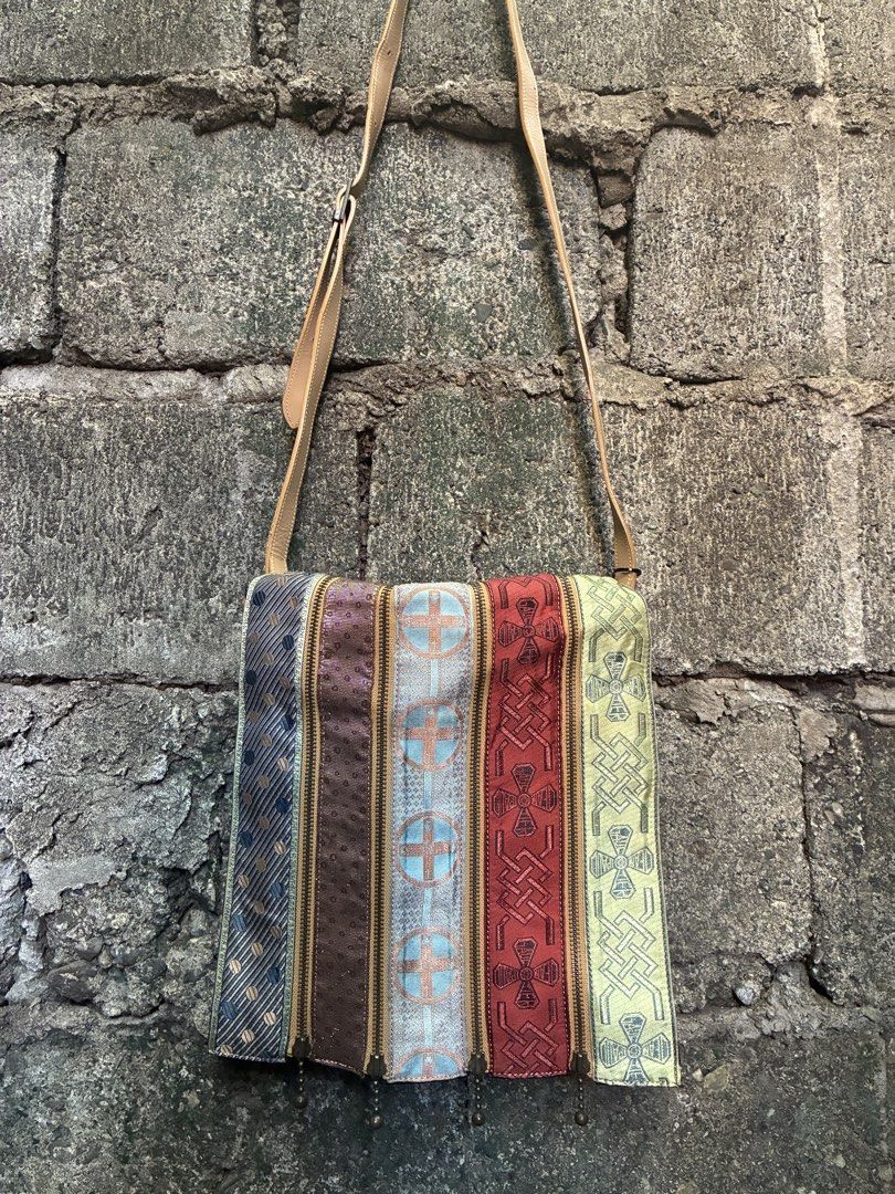 Jean Paul Gaultier multicolored patchwork shoulder bag (Category: Cross-body Bags) located in Manila. Submitted by assortedgoodsv3 (Listing ID 1467165659, Image 1). Description: Jean Paul Gaultier multicolored patchwork shoulder bag. Unique multi-stripe design with diverse textured fabric panels separated by zippers. Adjustable tan leather strap. Sturdy black canvas body with YKK hardware details on closures. Distinct statement piece with eclecti