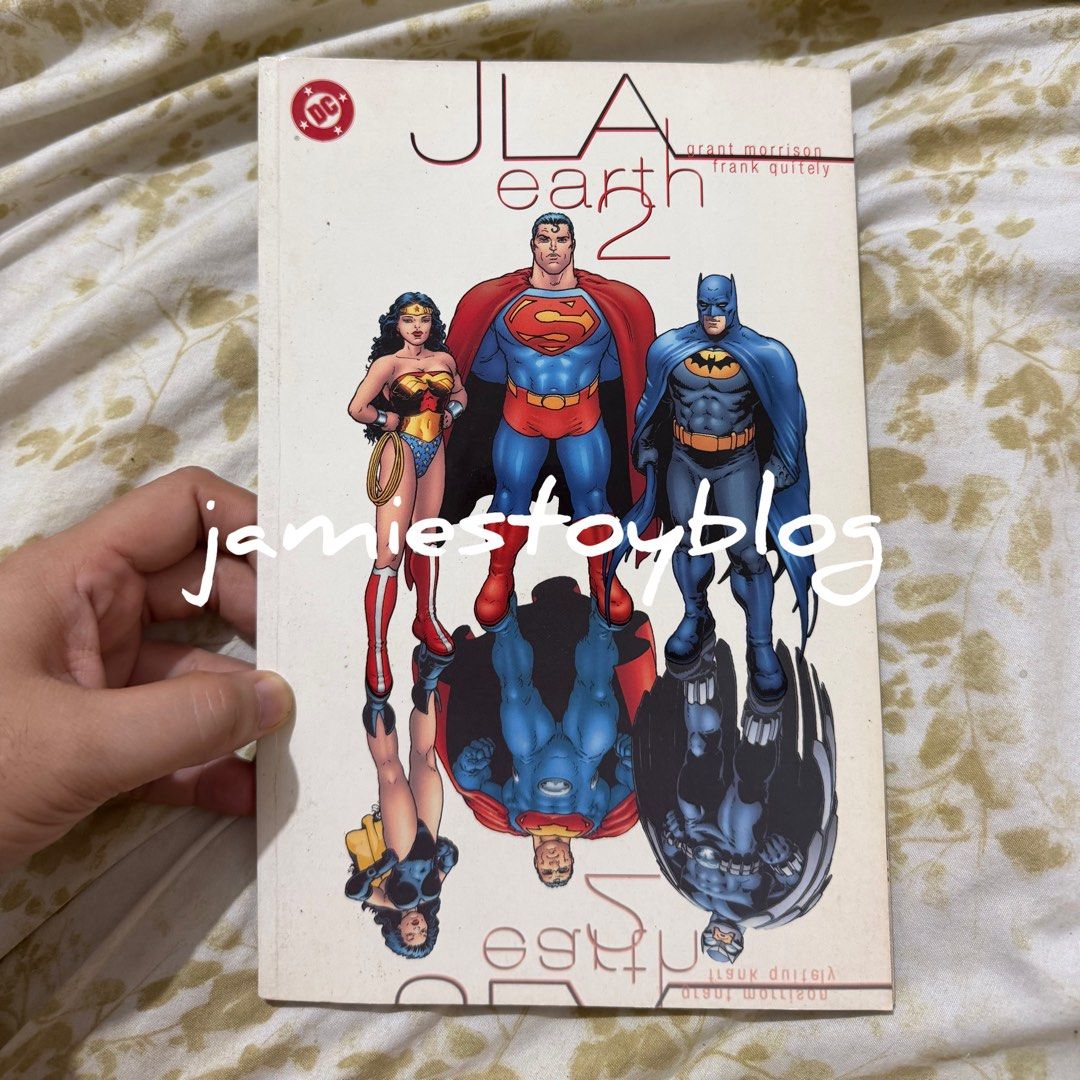JLA Earth 2 Graphic Novel by Grant Morrison (Category: Comics & Manga) located in Quezon City. Submitted by ohitsninja (Listing ID 1467126398, Image 1). Description: - Title: JLA Earth 2 Graphic Novel - Creator: Written by Grant Morrison with art by Frank Quitely - Publisher: DC Comics - Format: Softcover, full color interior - Condition: Clean interior pages with minor shelf wear on cover edges and corners - Perfect for: DC Comics and graphic no