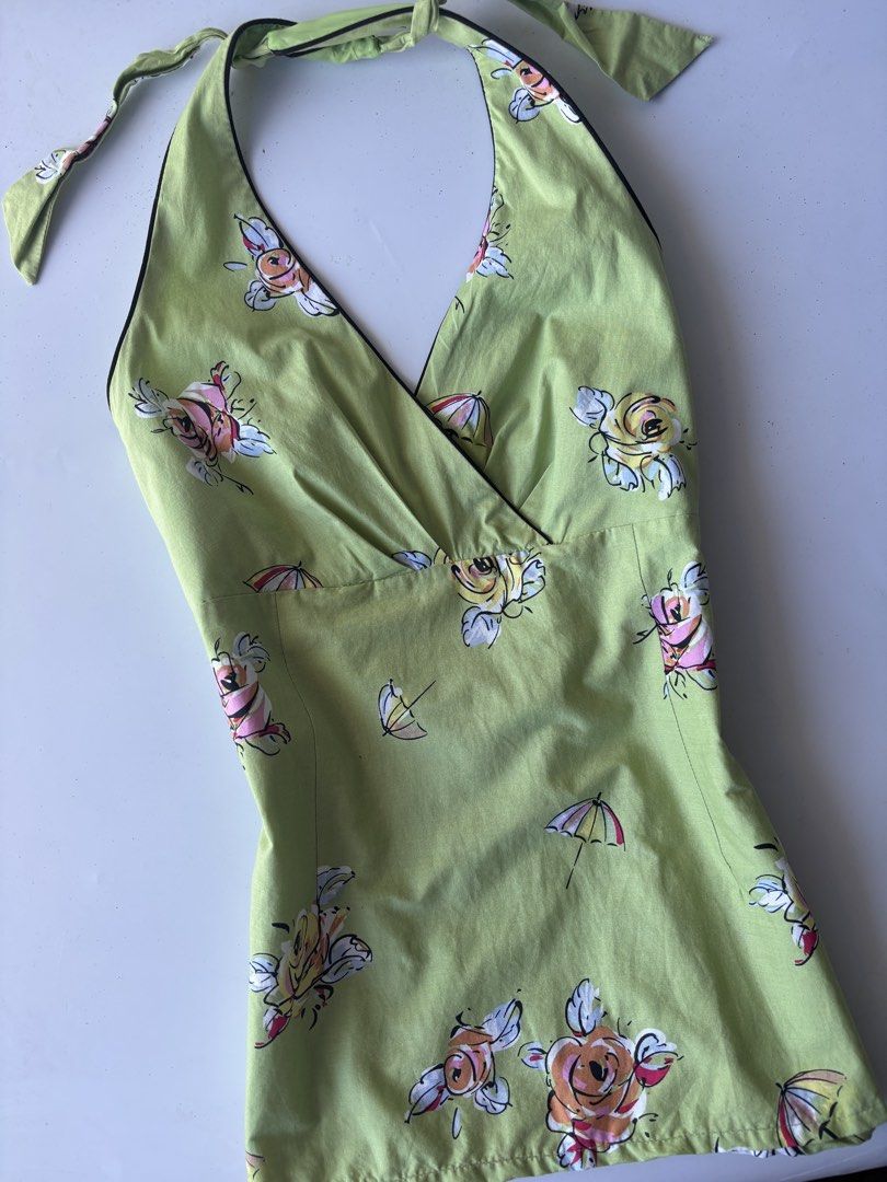K Studio Green Floral Halter Top (Category: Sleeveless) located in Batac City. Submitted by doniagel (Listing ID 1467124938, Image 2). Description: - Style: Green halter top with V-neck crossover front and black contrast trim - Print: Vibrant colorful roses and umbrella all-over pattern - Fit & Closure: Adjustable ties at the back of the neck, tag size 12 - Material: Comfortable cotton-spandex blend with smooth polyester lining - Condition: Brand