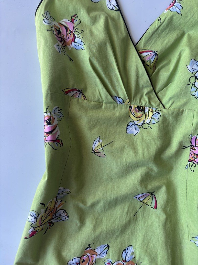 K Studio Green Floral Halter Top (Category: Sleeveless) located in Batac City. Submitted by doniagel (Listing ID 1467124938, Image 3). Description: - Style: Green halter top with V-neck crossover front and black contrast trim - Print: Vibrant colorful roses and umbrella all-over pattern - Fit & Closure: Adjustable ties at the back of the neck, tag size 12 - Material: Comfortable cotton-spandex blend with smooth polyester lining - Condition: Brand