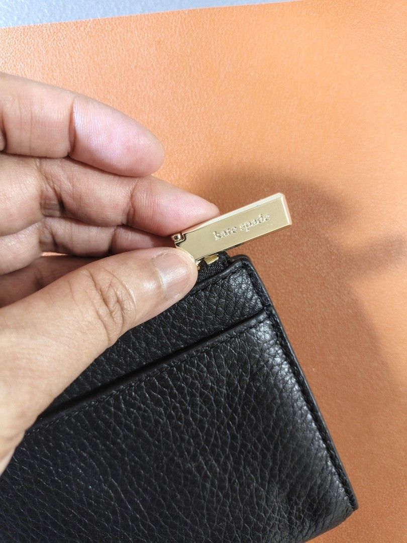 Kate Spade Black Leather Zip Around Wallet (Category: Wallets & Card holders) located in Quezon City. Submitted by closeta38 (Listing ID 1467000863, Image 3). Description: - Brand: Kate Spade New York - Material: Premium black pebbled leather - Hardware: Gold-tone with logo-stamped zipper pull - Closure: Snap closure - Interior: Multiple card slots, compartments, and clean lining with gold foil brand lettering - Size: Compact and lightweight, per