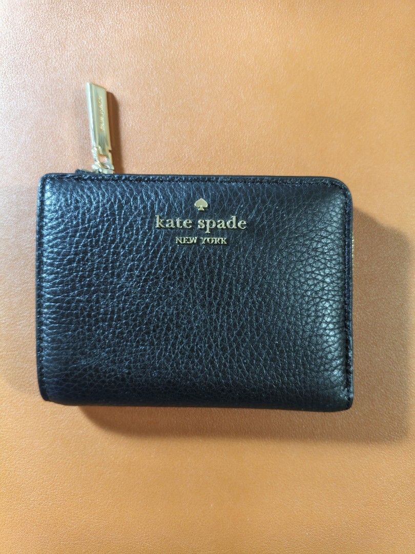 Kate Spade Black Leather Zip Around Wallet (Category: Wallets & Card holders) located in Quezon City. Submitted by closeta38 (Listing ID 1467000863, Image 1). Description: - Brand: Kate Spade New York - Material: Premium black pebbled leather - Hardware: Gold-tone with logo-stamped zipper pull - Closure: Snap closure - Interior: Multiple card slots, compartments, and clean lining with gold foil brand lettering - Size: Compact and lightweight, per