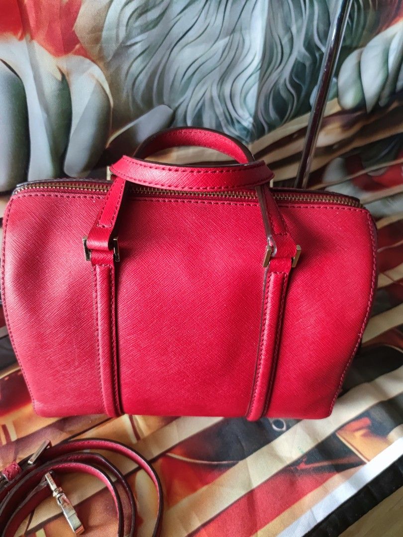 Kate Spade Red Saffiano Leather Satchel (Category: Luxury Bags & Wallets) located in Dagupan City. Submitted by jhazrightshop (Listing ID 1467055267, Image 2). Description: - Brand: Kate Spade - Material: Structured saffiano leather in a bright red shade - Hardware: Elegant gold-tone accents - Versatile Carry: Dual top handles and a detachable matching shoulder strap for crossbody wear - Closure: Secure zip-top closure - Condition: Clean exterior
