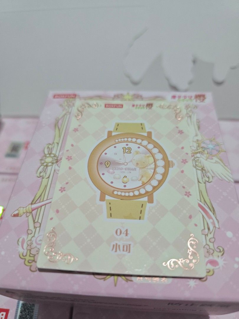 Kero-chan 04 (Category: Raw Singles) located in Mandaluyong City. Submitted by tsukineko0613 (Listing ID 1467020241, Image 2). Description: - Brand: Boxfun - Item: Cardcaptor Sakura Card #04 (Kero-chan watch design) - Design: Pastel yellow and pink checkered background with metallic foil frame details - Condition: Clean edges, properly stored, and well-maintained - Perfect for collection, display, or gifting to fellow anime fans!.