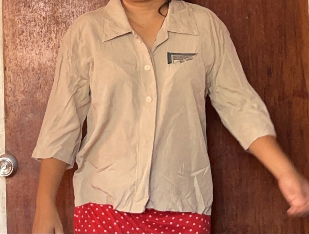 Key Wear Beige Button-Down Shirt (Category: Shirts) located in Toledo. Submitted by klnmia (Listing ID 1466973223, Image 1). Description: - Brand: Key Wear - Color: Versatile beige - Material: Soft and lightweight viscose blend - Design: Classic collar with 3/4 length sleeves - Detail: Embroidered chest pocket with sparkly bead logo - Style: Easy to dress up for work or keep casual for everyday wear.