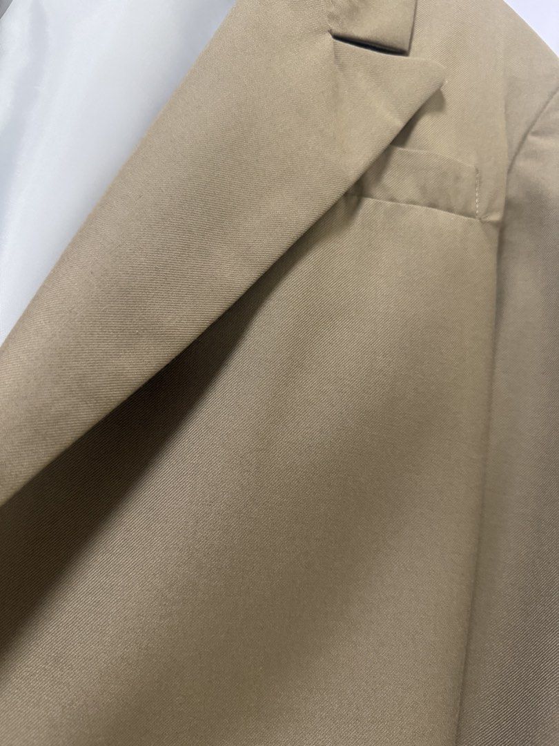 Khaki beige cropped blazer jacket open front (Category: Coats, Jackets and Outerwear) located in Quezon City. Submitted by lovedbymaxandmikoy (Listing ID 1466975144, Image 2). Description: - Color: Khaki beige with white inner lining - Fit: Cropped, boxy open-front style - Details: Structured lapels and one front pocket - Fabric: Clean material with visible diagonal weave texture - Style: Versatile for casual or smart-casual wear.