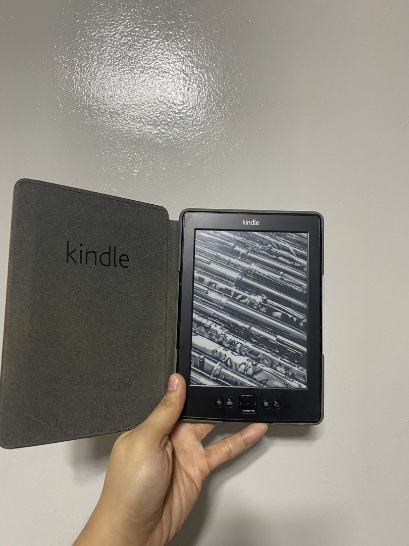 Kindle E-Reader 4th Generation (Category: E-Readers) located in Pasacao. Submitted by wengpullar37205 (Listing ID 1467127999, Image 1). Description: - Brand/Model: Kindle 4th Generation E-Reader - Includes a protective brown case with visible wear from normal use - Features physical navigation buttons and e-ink screen for comfortable reading - Compact, lightweight, and easy to carry around - Fresh from the box working nmn po,ku na magkalikot -Don