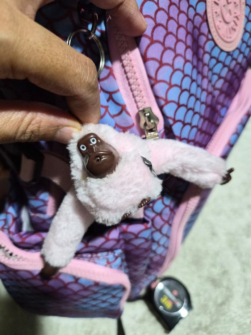 Kipling Mermaid Scale Pink Blue School Backpack Bag (Category: Backpacks) located in Mandaue City. Submitted by chuchi152615 (Listing ID 1466985514, Image 3). Description: Kipling backpack with purple and blue mermaid scale print. Pink zippers and straps throughout. Includes the matching light pink monkey keychain dangling from the front zipper. Padded shoulder straps with chest buckle for secure carrying. Multiple front zip compartments for stor