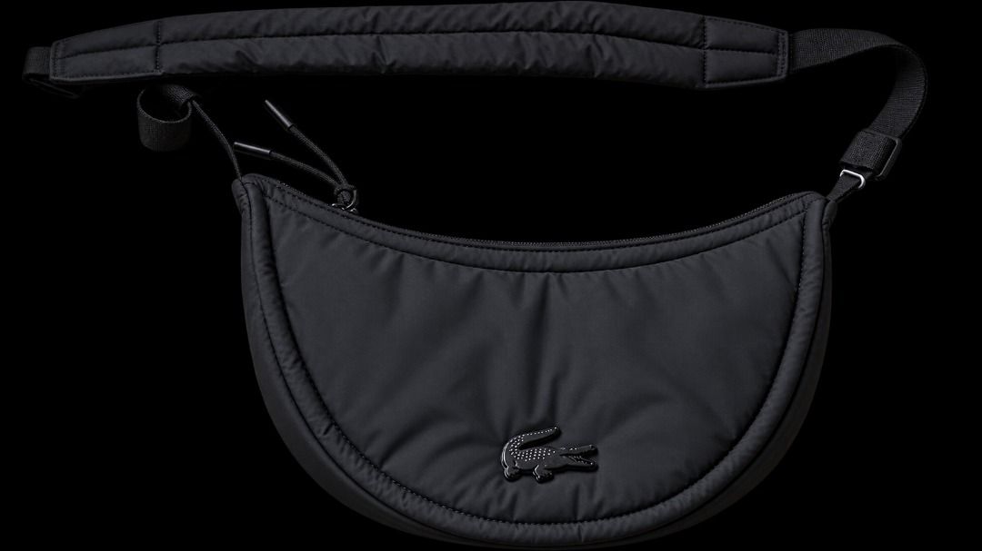 Lacoste Black Crescent Crossbody Bag (Category: Cross-body Bags) located in Quezon City. Submitted by pyress (Listing ID 1467062621, Image 1). Description: - Brand: Lacoste - Style: Crescent crossbody bag - Color: Black - Material: Soft quilted nylon - Strap: Adjustable with comfort padding - Closure: Main zip with dual pull cords - Interior: Zippered pocket and branded leather patch - Condition: Brand new with original store tags attached.