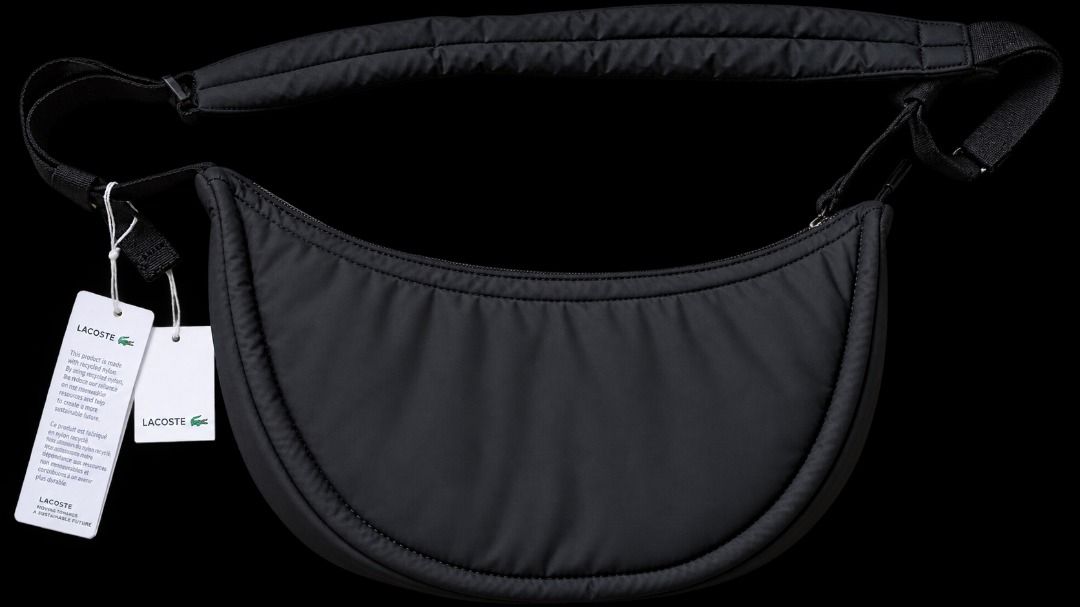 Lacoste Black Crescent Crossbody Bag (Category: Cross-body Bags) located in Quezon City. Submitted by pyress (Listing ID 1467062621, Image 2). Description: - Brand: Lacoste - Style: Crescent crossbody bag - Color: Black - Material: Soft quilted nylon - Strap: Adjustable with comfort padding - Closure: Main zip with dual pull cords - Interior: Zippered pocket and branded leather patch - Condition: Brand new with original store tags attached.